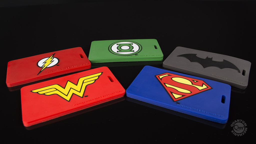 Clockwise from top left: Flash, Green Lantern, Batman, Superman & Wonder Woman Q-Tags.